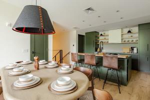 a dining room with a table and a kitchen at Spruce Peak Resort luxury 3 Bedrm 2levelApartment in Stowe +67 photos