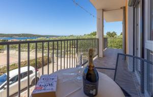 a bottle of wine sitting on a table on a balcony at Nice Apartment In Barbat With Wifi in Barbat na Rabu