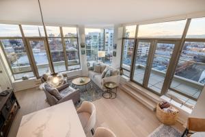 a living room with a view of a city at Victoria's SEA-Cret-Stunning Olympic and Inner Harbour Views from 450 sq ft Balcony in Victoria