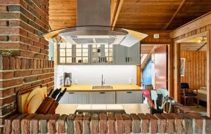 a kitchen with a sink and a stove at Holiday Home Skovbrynet Tarm V in Hemmet