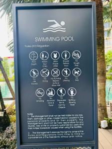 a sign for a swimming pool with signs on it at My Service Suites Agile KL in Kuala Lumpur
