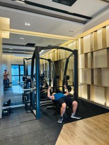 a man in a gym with a simulator at My Service Suites Agile KL in Kuala Lumpur