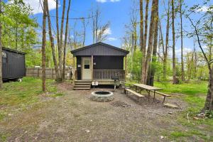 a small cabin with a picnic table and a bench at Family Cabin full bath in Gaines +31 photos