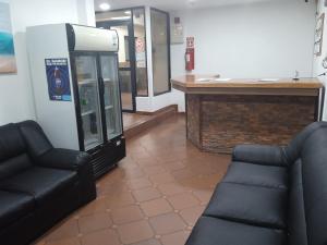 a waiting room with two chairs and a phone booth at Hotel Altamira La Puerta in Punta Cardón