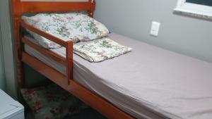 a bunk bed with two pillows on top of it at Hospedagem Cinelândia AP 617 in Rio de Janeiro