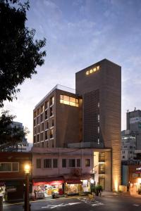 a building with a sign on top of it at Cont Hotel in Busan