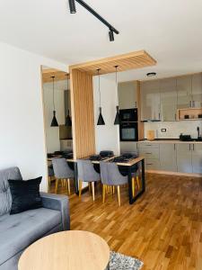 a living room with a couch and a table at Belle Vue Apartmani in Zlatibor