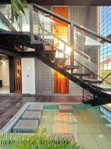 a house with a swimming pool and a staircase at Villa Shinta1 with 3 BR, Pool & WiFi in Ungasan Bali by Damaresa in Uluwatu