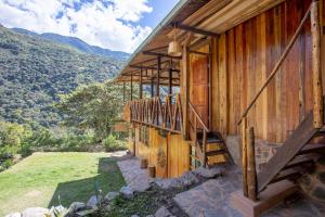 a wooden house with a staircase on the side of it at Viamonte EcoLodge in Santa Teresa