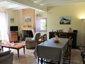 a living room with a table and a fireplace at Maison à Lamonzie-Saint-Martin avec Piscine et Animaux admis - FR-1-616-112 in Lamonzie-Saint-Martin