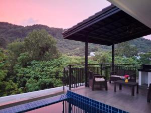 a view from the deck of a villa with a pool at Private Valley View pool villa Phuket in Ban Klang