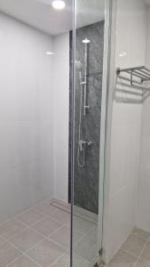 a bathroom with a shower with a glass door at Private Valley View pool villa Phuket in Ban Klang
