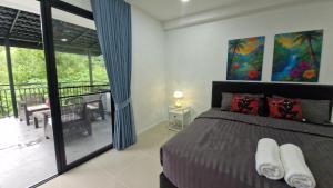 a bedroom with a bed and a balcony at Private Valley View pool villa Phuket in Ban Klang +42 photos