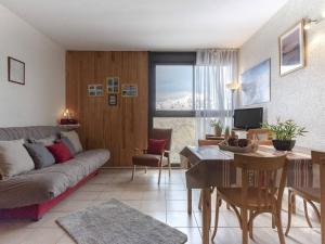 a living room with a couch and a table at Appartement à Saint Lary, proche pistes, animaux admis - FR-1-296-519 in Saint-Lary-Soulan