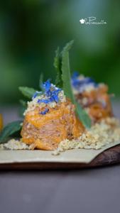 two pieces of food on a plate with blue sprinkles at Locanda dell'Angelo in Valle dellʼAngelo