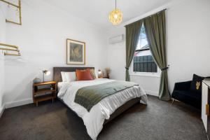 ein Schlafzimmer mit großem Bett und Fenster in der Unterkunft The Velvet Cottage in Adelaide