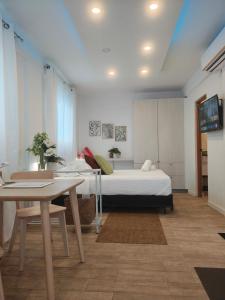 a bedroom with a bed and a table in it at New! Cozy Cool Studio Near Beach! in San Juan