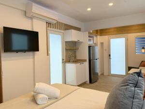 a room with a bed and a tv on the wall at New! Cozy Cool Studio Near Beach! in San Juan +14 photos