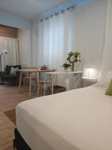 a bedroom with a bed and a table and chairs at New! Cozy Cool Studio Near Beach! in San Juan