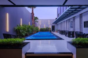 a swimming pool in the middle of a building at Aston Gejayan Yogyakarta Hotel & Conference Center in Yogyakarta