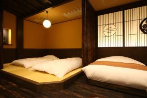 Postel nebo postele na pokoji v ubytování Liberty Resort 久能宿