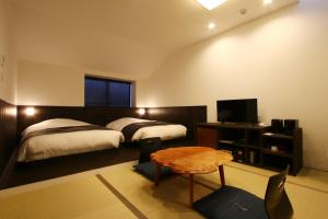 Postel nebo postele na pokoji v ubytování Liberty Resort 久能宿