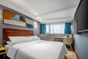 a bedroom with a large white bed and a desk at Weiting Light Hotel Shanghai University of Finance and Economics in Shanghai +13 photos