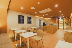 a restaurant with tables and chairs in a room at Cheonan Buldang Hound Hotel in Cheonan
