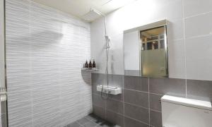 a bathroom with a shower with a toilet and a mirror at Nowon Luxe Hotel in Seoul +11 photos