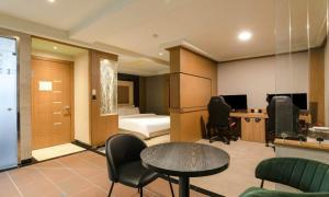 a room with a table and chairs and a bedroom at Nowon Luxe Hotel in Seoul