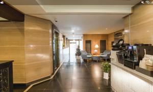 a lobby of a hotel with chairs and tables at Nowon Luxe Hotel in Seoul