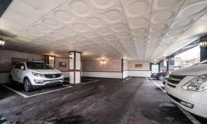 a parking lot with two cars parked in it at Nowon Luxe Hotel in Seoul