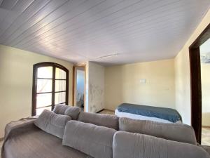 a living room with a couch and a bed at Casa da Marta in Guaratuba +25 photos