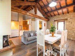 a kitchen and living room with a table and a couch at Beautiful Apartment in Sestino with Garden in Sestino