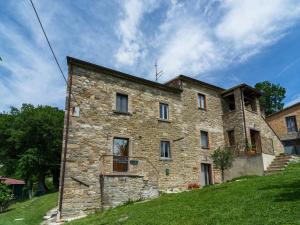 an old stone building on a grassy hill at Beautiful Apartment in Sestino with Garden in Sestino