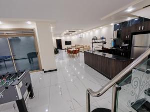 a large room with a kitchen and a dining room at Wonder Villa in Al Rama