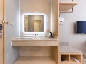 a bathroom with a sink and a mirror at Vienna Suzhou Oriental Gate Jinji Lake in Suzhou +96 photos