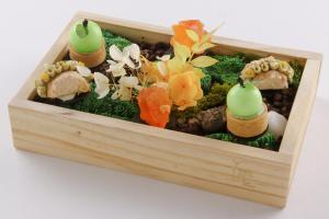a wooden box filled with vegetables and sushi at The Landis Taipei in Taipei