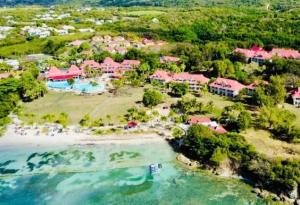 an aerial view of a resort on a beach at TIKAZADAPH, pour un séjour de charme, romantique & exotique, 97180 Sainte-Anne in Sainte-Anne