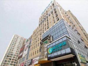 a tall building with a sign in front of it at City Comfort Inn Hefei Shuanggang Fuyang Road in Hefei