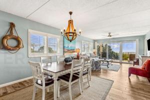 a dining room and living room with a table and chairs at N1 Amelia South apts in Fernandina Beach