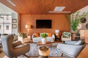 a living room with a couch and a tv at Luxury Pool View Suite at 5-Star Hotel in Punta Cana