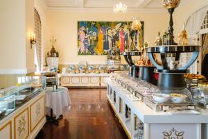 a buffet line in a restaurant with food on display at Dalat Palace Heritage Hotel in Da Lat