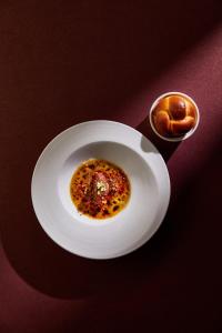 a white plate with a piece of food on a table at The Landis Taipei in Taipei
