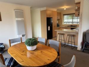 a wooden table with a potted plant on it in a kitchen at Rosebud Family Retreat in Rosebud +4 photos