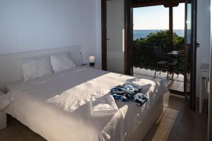 a bedroom with a bed with a view of the ocean at Step to Paradise in Pelion in Agios Ioannis Pelio