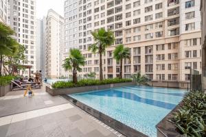 a swimming pool in the middle of a city with tall buildings at Stylist Studio Saigon Royal Hana Apart in Ho Chi Minh City