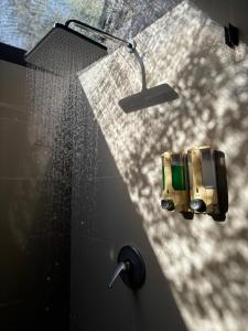 une salle de bain avec une douche avec pommeau de douche dans l'établissement Island Cabanas Formerly Taman Sari Villa, à Nusa Lembongan