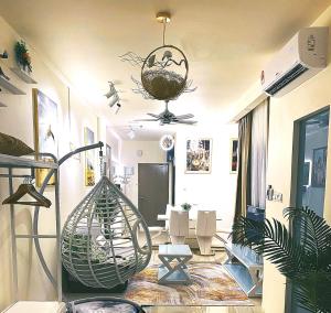 a living room with a hanging plant at Manhattan Suites @ ITCC in Kota Kinabalu