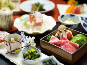 a table topped with plates of food on a table at kanazawayuwakuonsen nihonryourisakaeya in Kanazawa